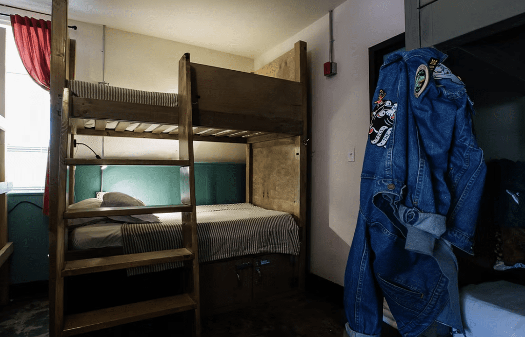 Freshly made bunk beds in a dorm room at the Firehouse Hostel